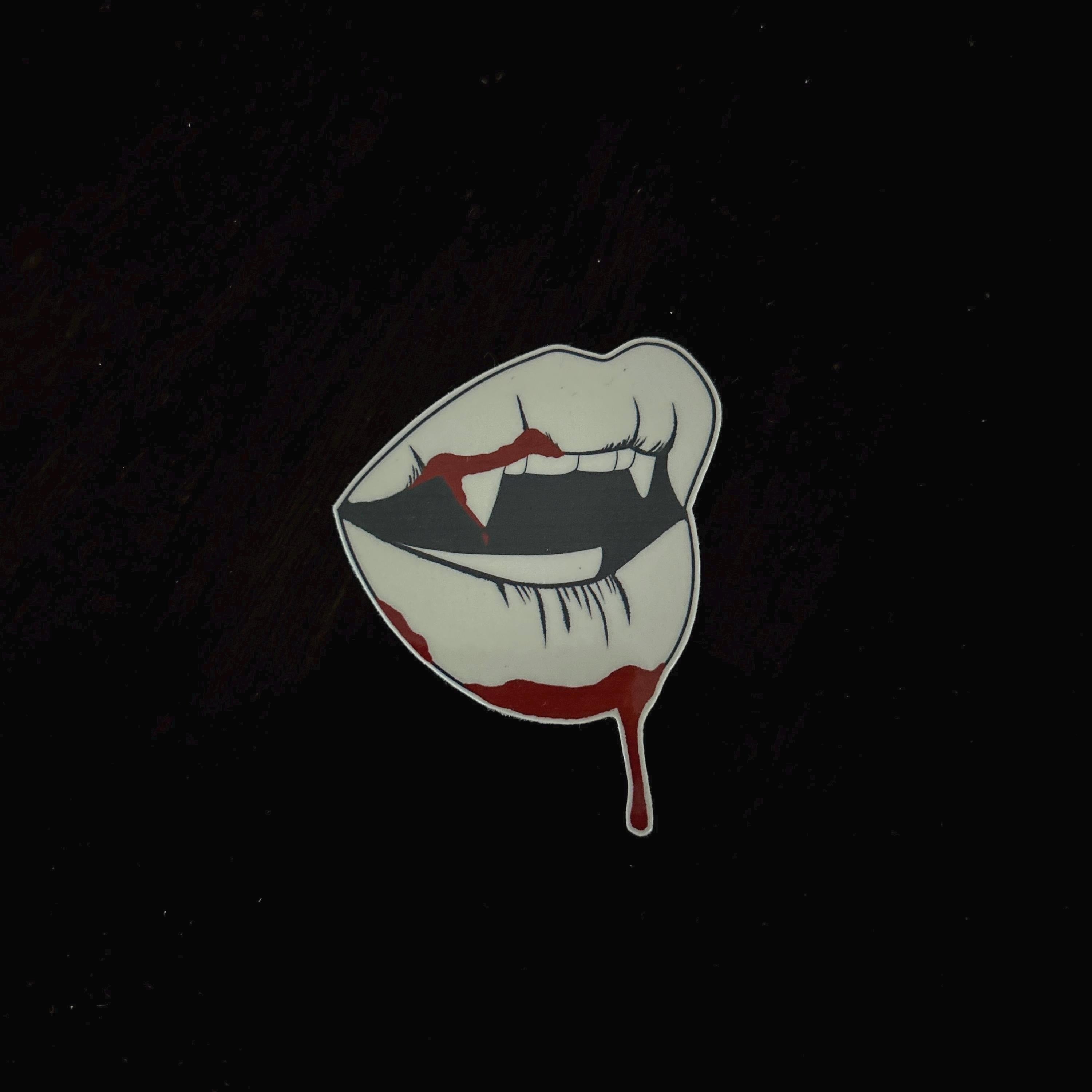 Illustration of a mouth with fangs and blood on a black background