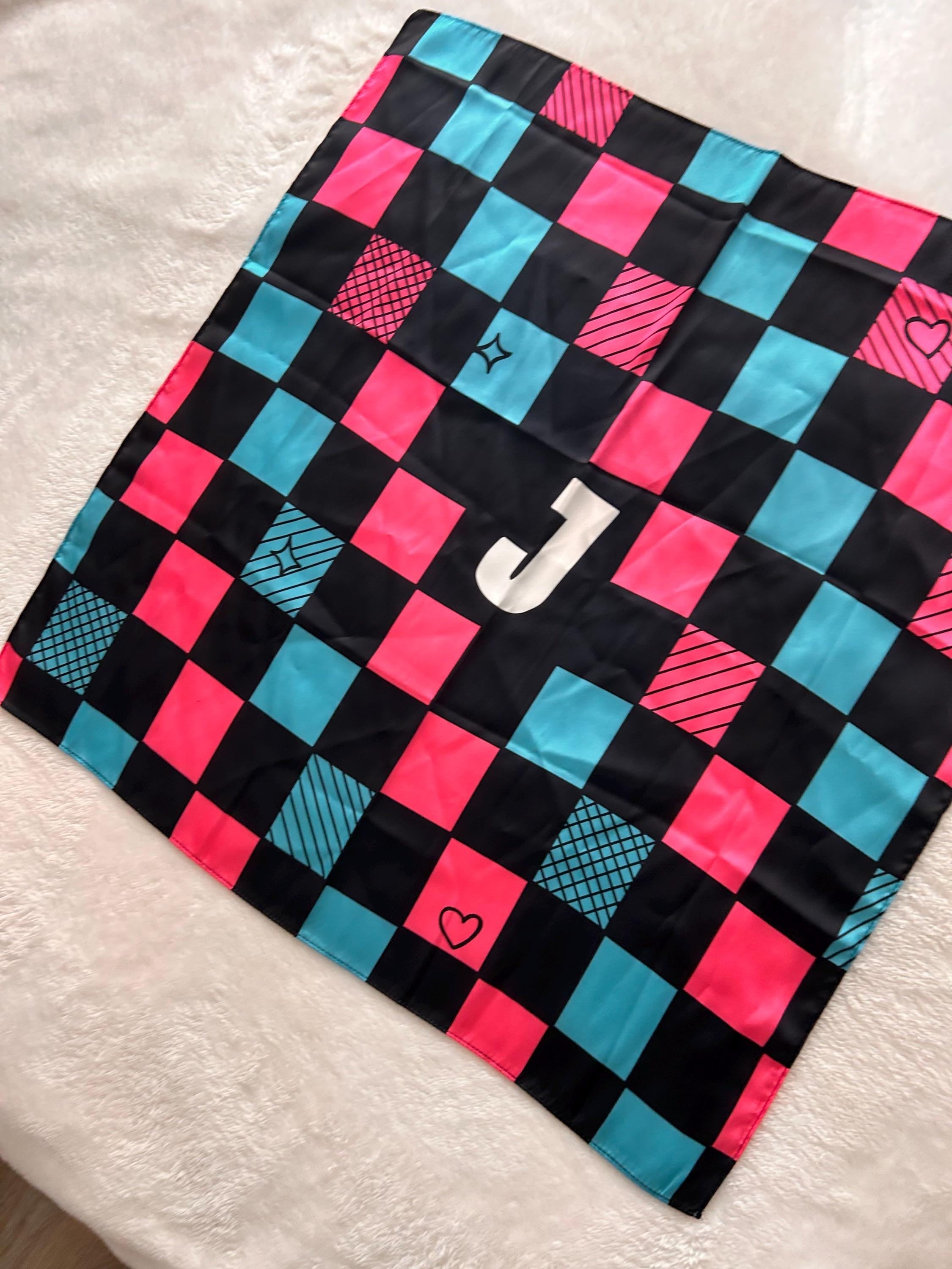 Checkered fabric with pink and blue squares on a white surface